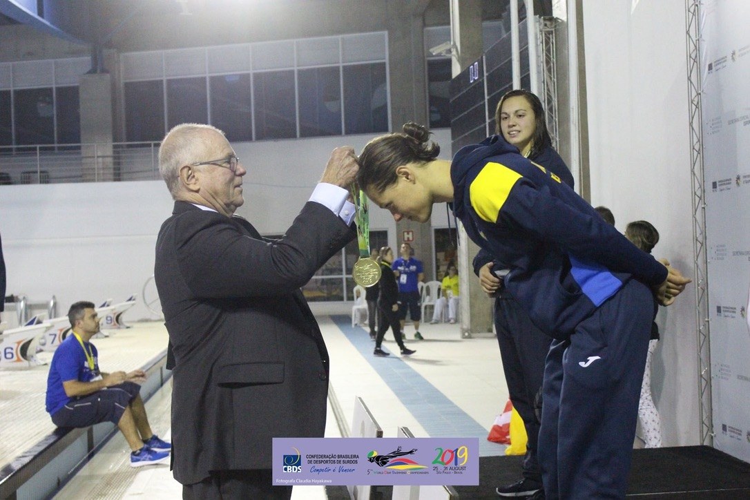 Maria Rezhylo receiving a gold medal at the 2019 World Deaf Swimming Championships